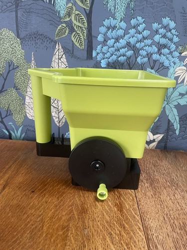 Hand held seed spreader - held,